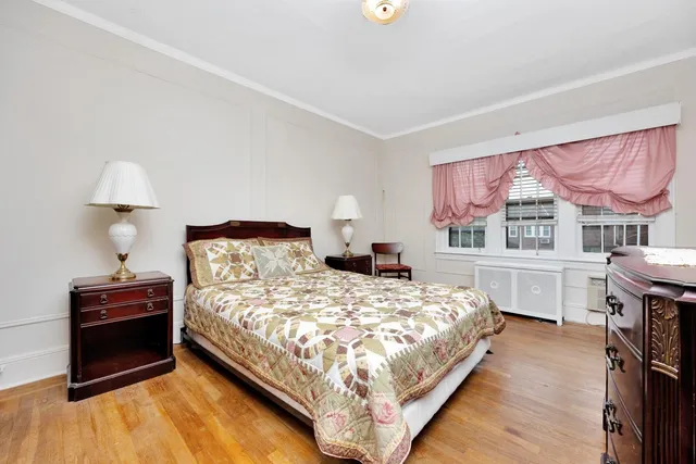 a bedroom with a bed and a closet with window