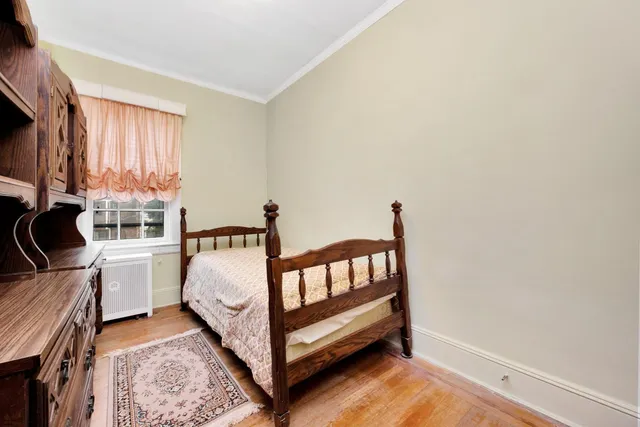 a spacious bedroom with a bed and a window