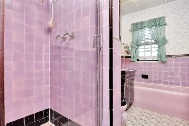 a bathroom with a bathtub and shower