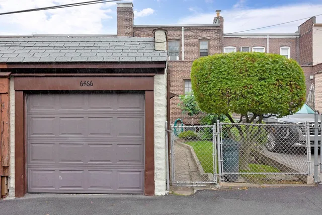 a view of a house with a wooden fence