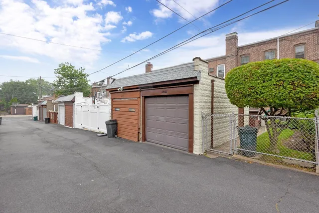 a view of a house with a garage and balcony