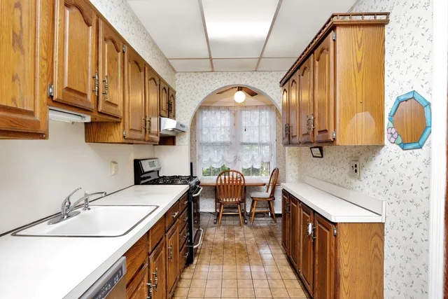 a kitchen with a sink a stove and a refrigerator