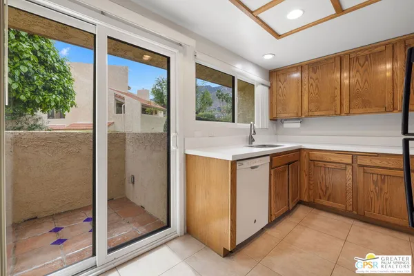 a kitchen with a sink window and cabinets