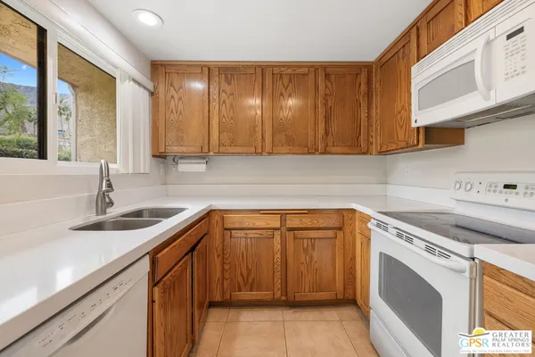 a kitchen with a sink cabinets and window