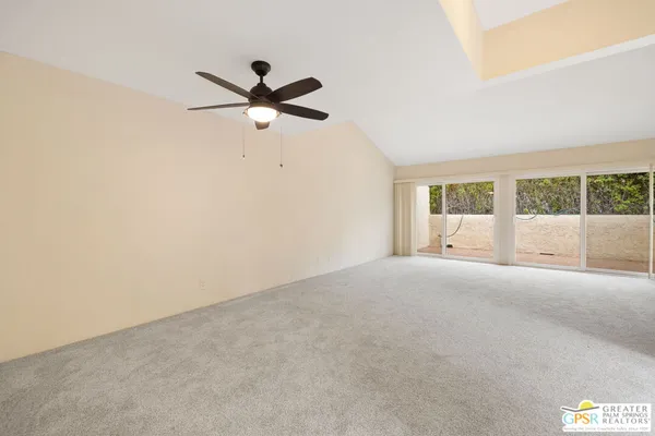 a view of a livingroom with a ceiling fan and window