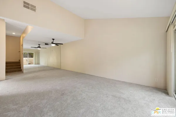 a view of a big room with closet and windows