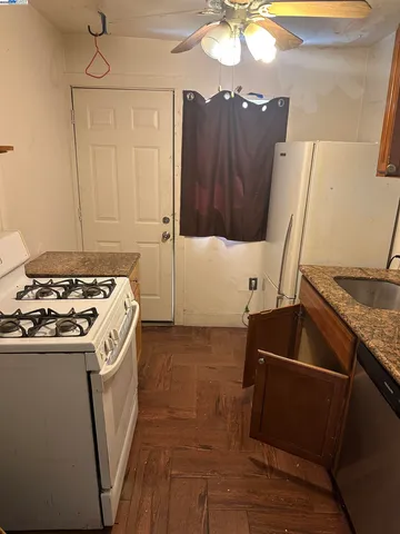 a kitchen with sink a refrigerator and a stove