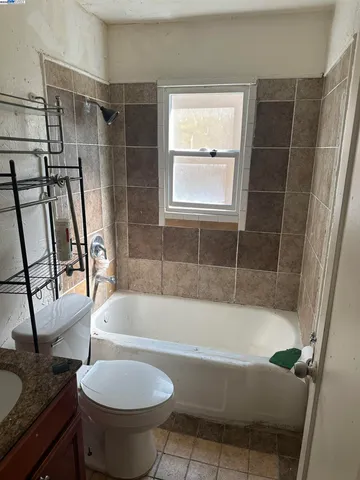 a white bath tub sitting next to a toilet