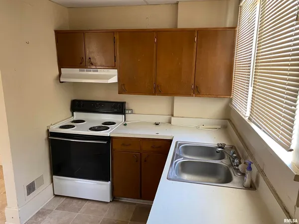 a kitchen that has a sink and a stove