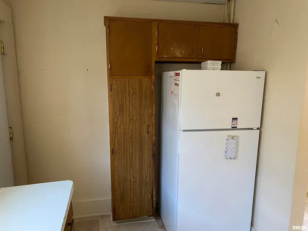 a white refrigerator freezer and a sitting area