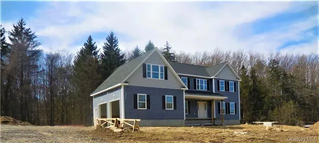 a front view of a house with mountain view