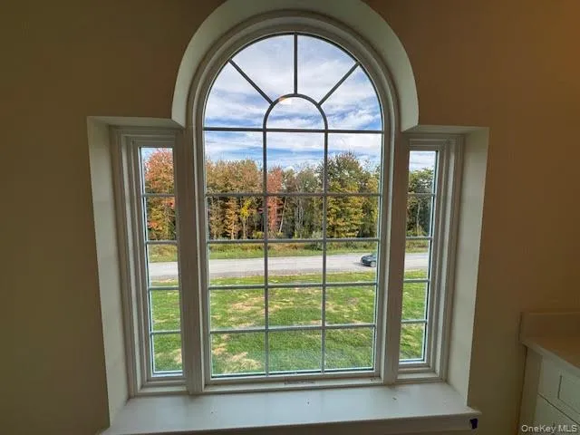 an empty room with wooden floor and a window
