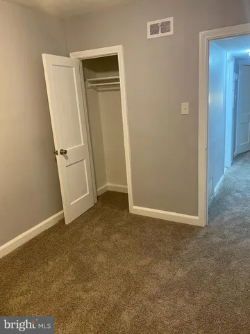 a view of a hallway to rooms