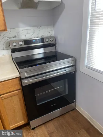 a stove top oven sitting inside of a kitchen