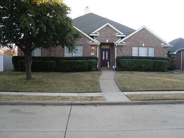 a front view of a house with yard