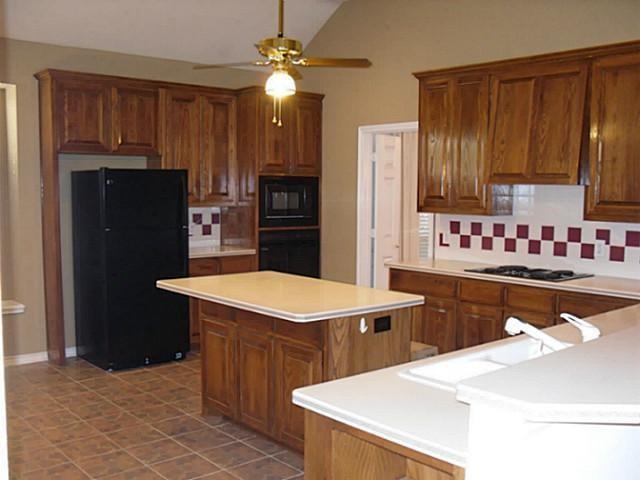 3824 Lowrey Way Plano, TX 75025 - Photo 7 of 10 a kitchen with stainless steel appliances a sink dishwasher stove refrigerator and cabinets