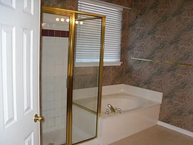 a bath tub sitting next to a shower