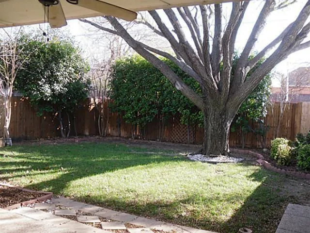 a tree in the garden of a house