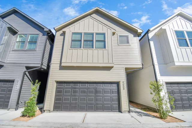 a front view of a house with garage
