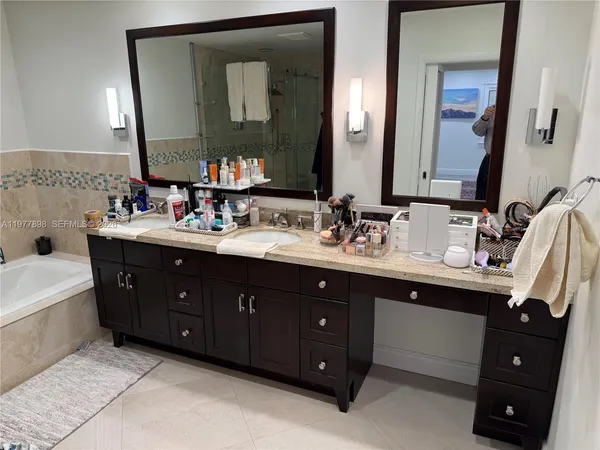 a bathroom with a double vanity sink and mirror