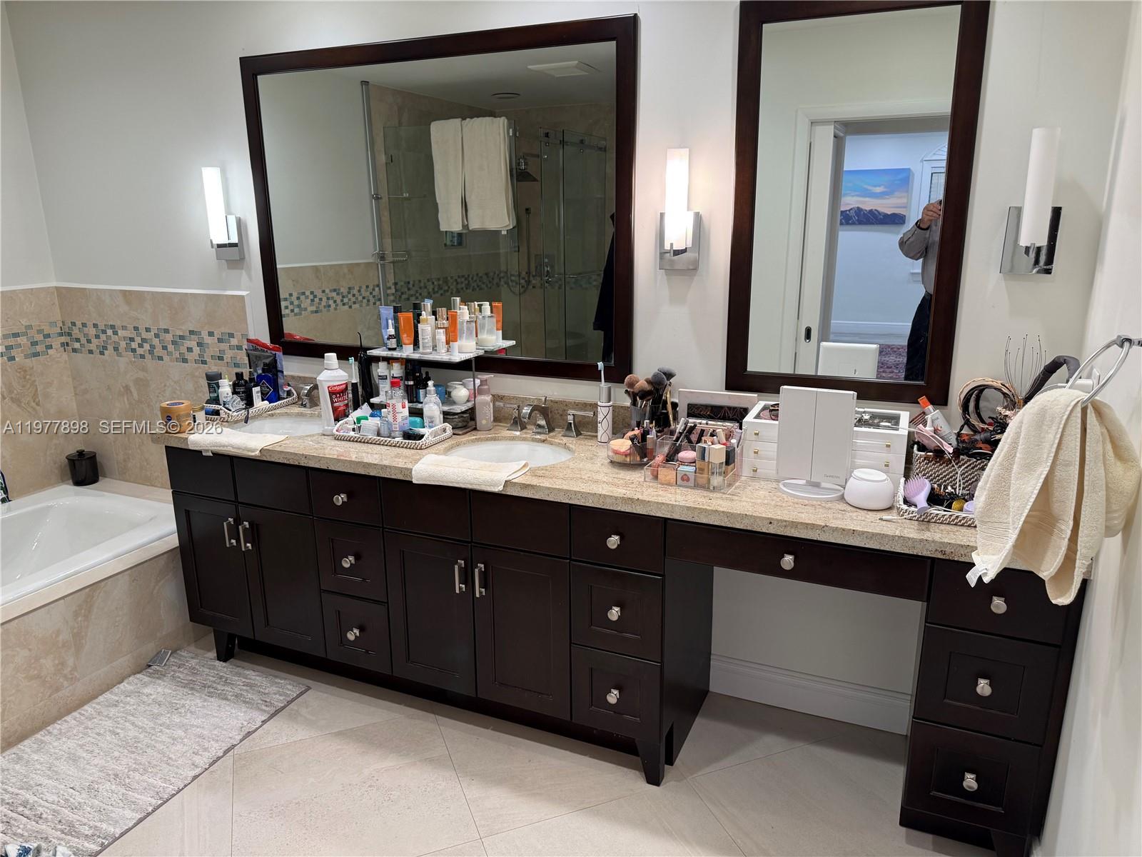 6399 Southwest 100th Street Pinecrest, FL 33156 - Photo 13 of 21 a bathroom with a double vanity sink and mirror