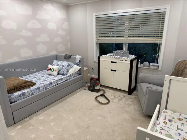 a bedroom with a bed and a couch