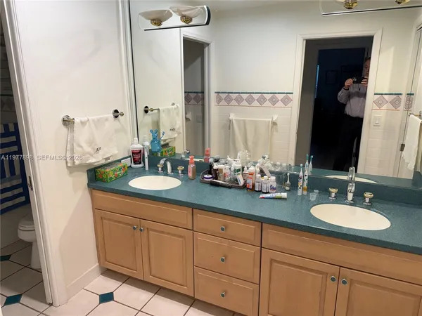a bathroom with a double vanity sink and a mirror