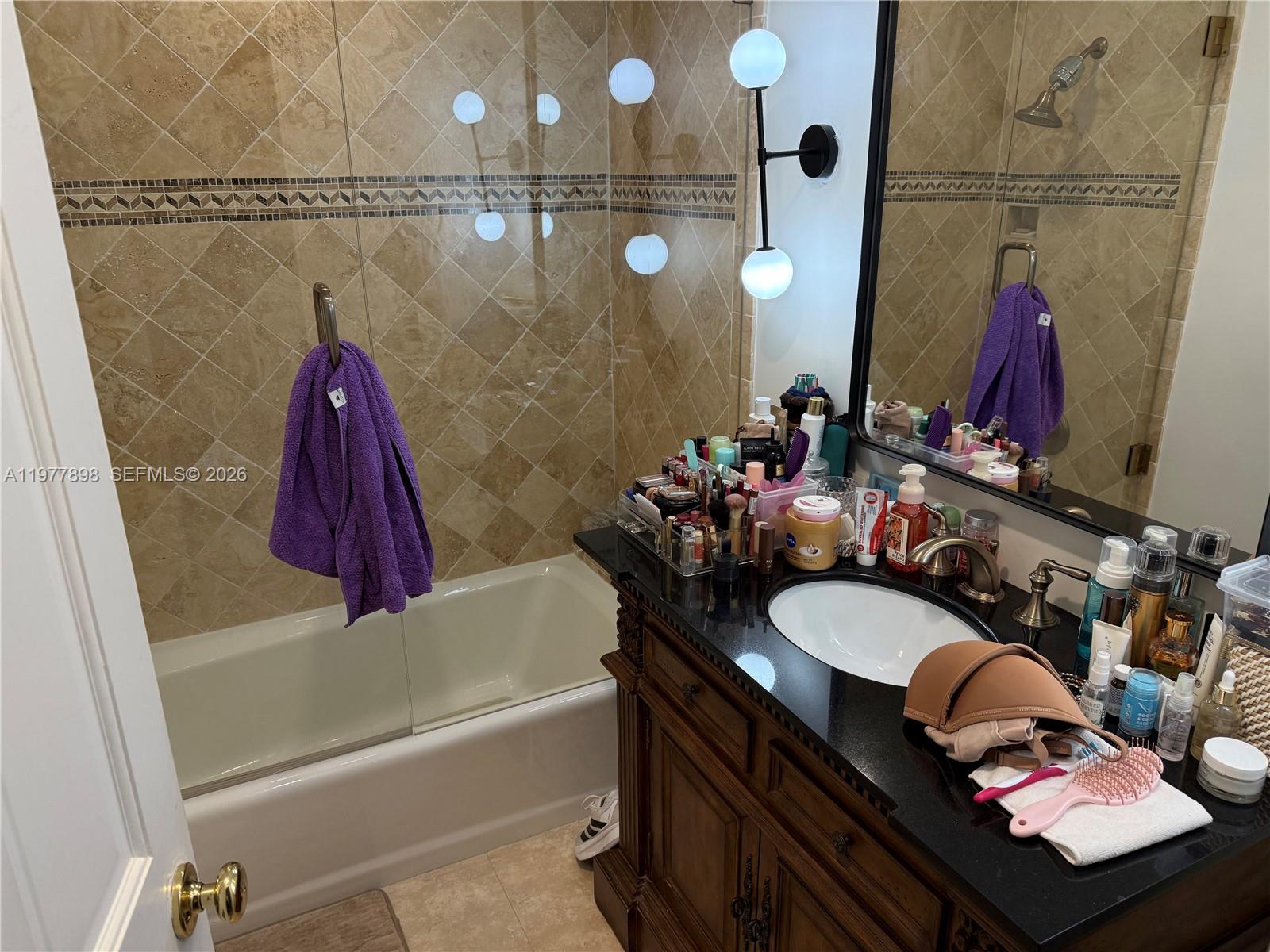 6399 Southwest 100th Street Pinecrest, FL 33156 - Photo 18 of 21 a bathroom with a granite countertop sink a toilet and shower