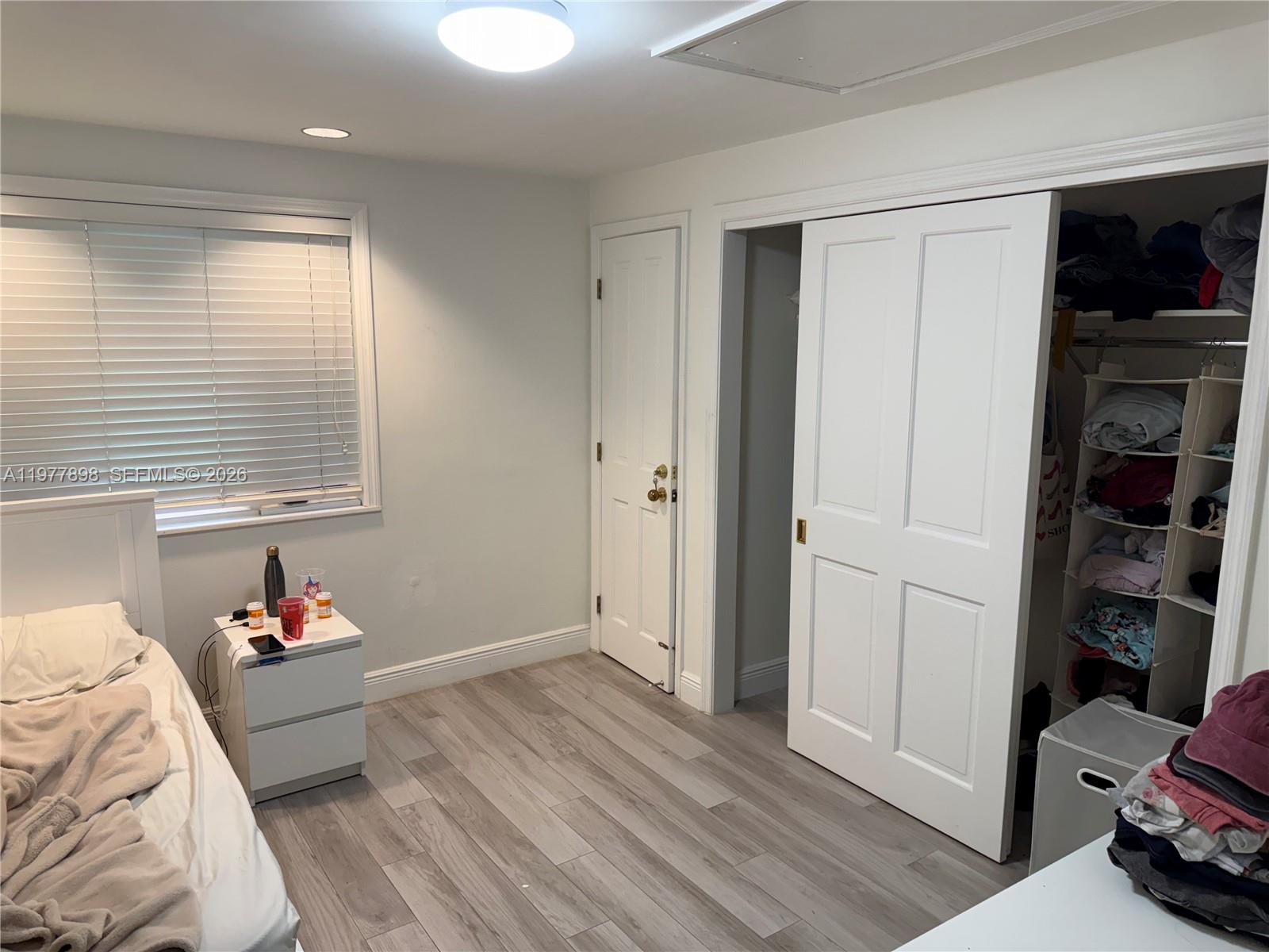 6399 Southwest 100th Street Pinecrest, FL 33156 - Photo 19 of 21 a bedroom with a bed and a window