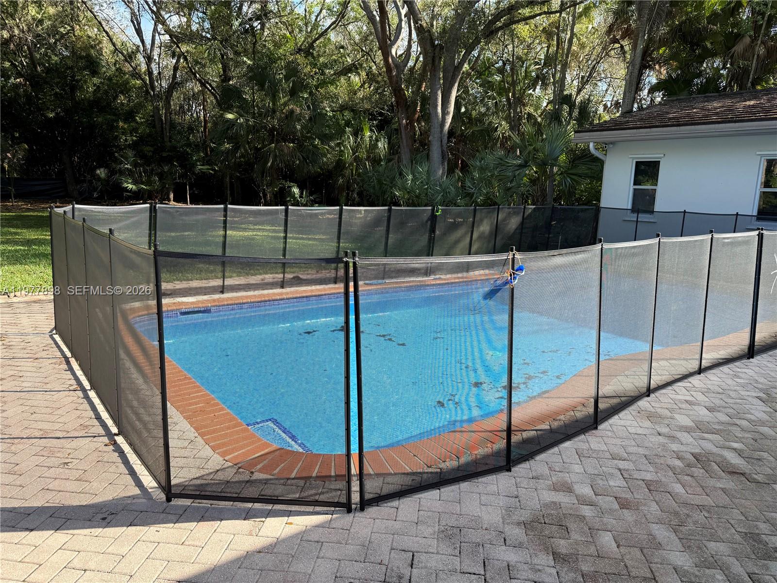 6399 Southwest 100th Street Pinecrest, FL 33156 - Photo 21 of 21 a view of a backyard with wooden fence