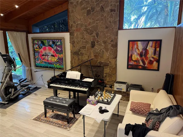 a living room with furniture a rug and a wall painting