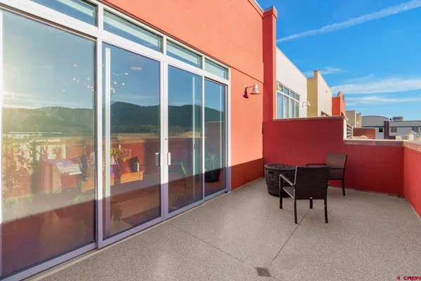 a balcony with furniture and a potted plant