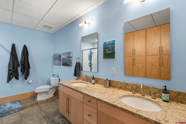 a bathroom with a toilet sink and shower