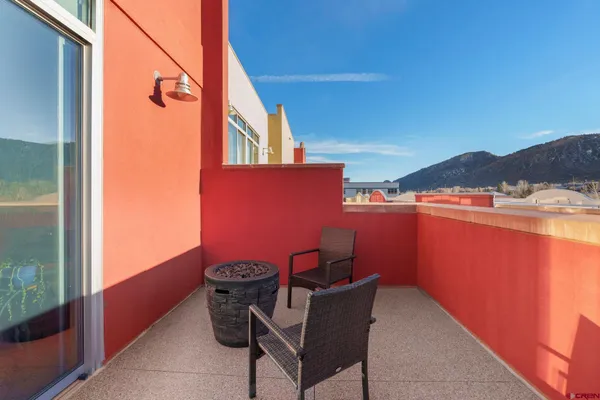 a view of balcony with furniture