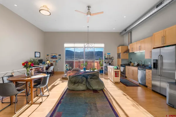 a living room with furniture a table and chairs