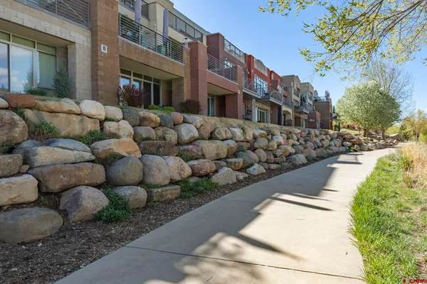 a view of a pathway with a wrought fence