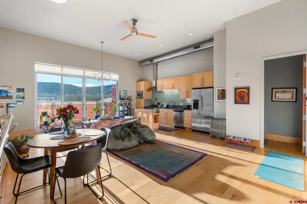 a living room with furniture and a floor to ceiling window