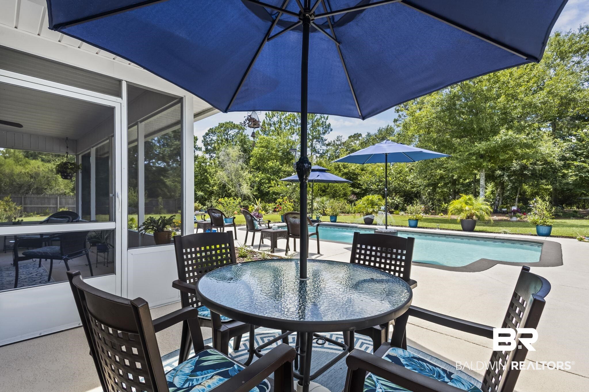 10473 Lyttleton Loop Lillian, AL 36549 - Photo 41 of 57 View of patio featuring outdoor dining area, an outdoor pool, a sunroom, and view of scattered trees