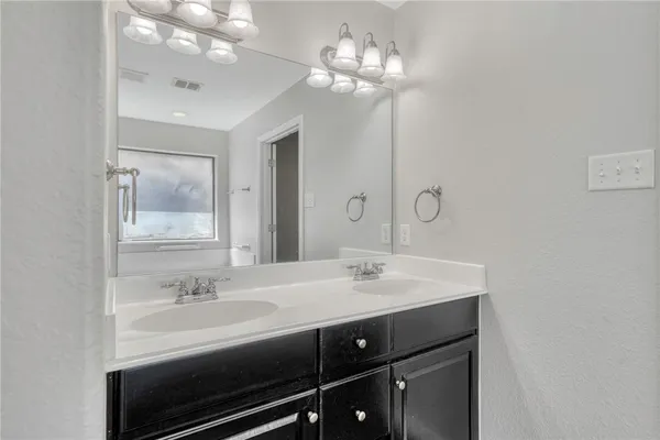 a bathroom with a sink double vanity and a mirror