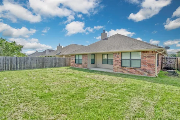 a view of a house with a backyard