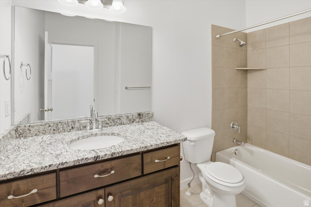 3636 West 910 South Syracuse, UT 84075 - Photo 30 of 70 Bathroom featuring a dark wood-finish vanity with a light speckled countertop, an integrated sink, and a large wall-mounted mirror