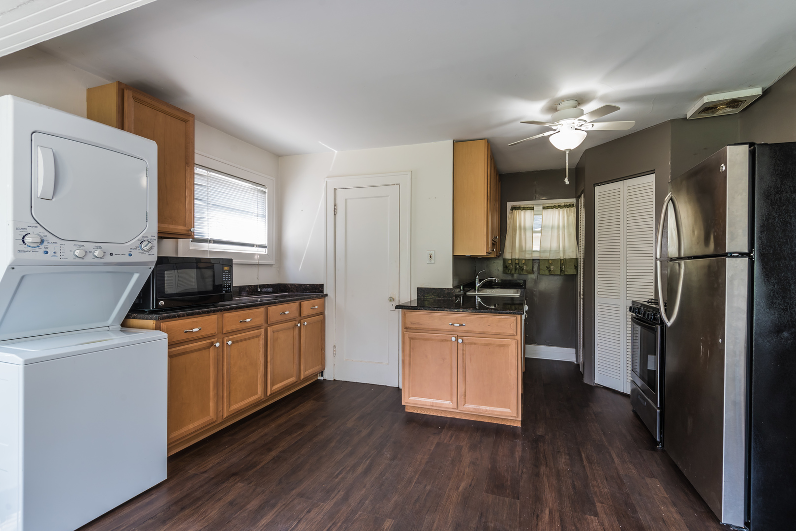 2109 Colfax Street Evanston, IL 60201 - Photo 3 of 12 a kitchen with granite countertop a refrigerator a sink dishwasher a stove and white cabinets with wooden floor