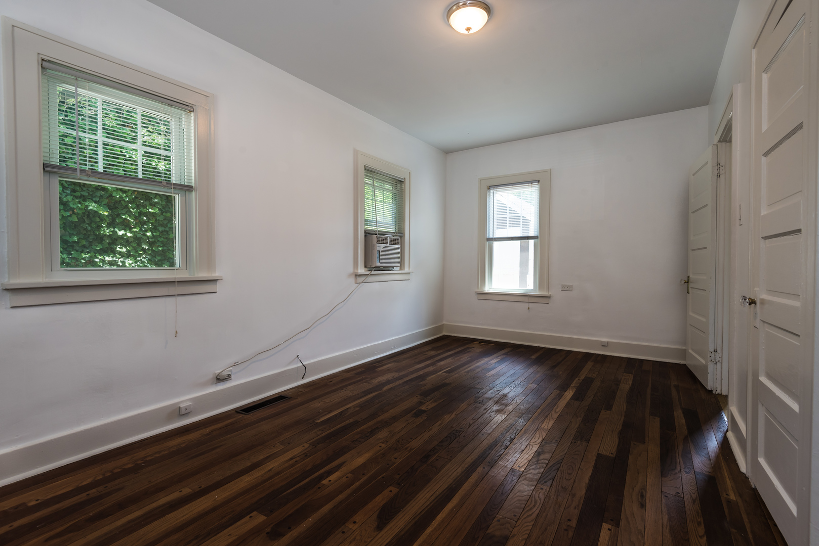 2109 Colfax Street Evanston, IL 60201 - Photo 4 of 12 a view of an empty room with wooden floor and a window