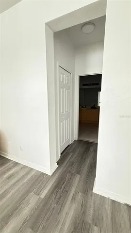 a view of a hallway with wooden floor