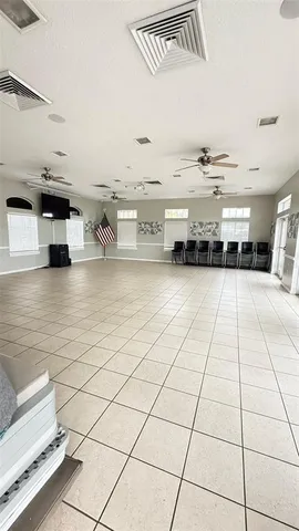 a living room with stainless steel appliances kitchen island granite countertop a sink and cabinets