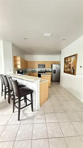 a view of kitchen with cabinets and window