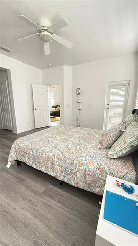 a bedroom with a bed and a mirror on the dresser