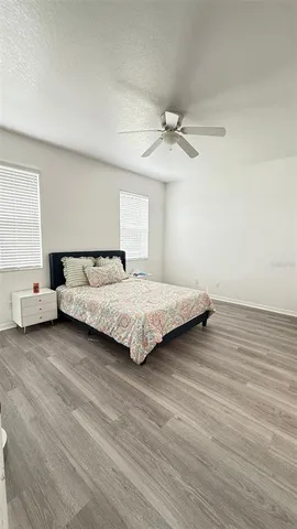 a bedroom with a bed and wooden floor