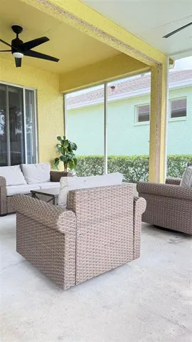 a living room with couches and potted plants