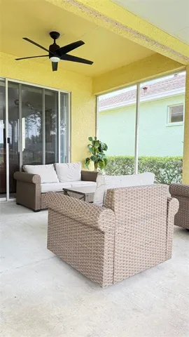 a living room with furniture and a floor to ceiling window